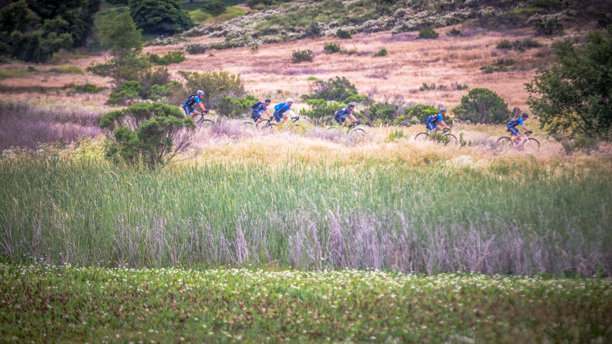 gravel riders in a field